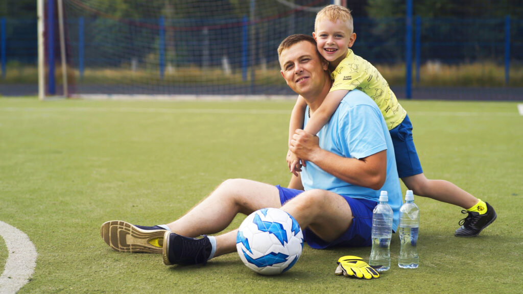 father and son relaxing after soccer practice